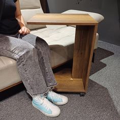 a person sitting on a couch next to a table