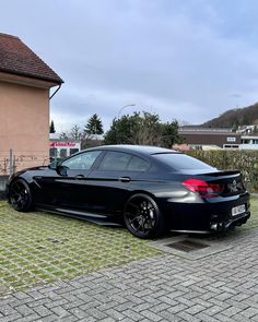 a black car parked in front of a house