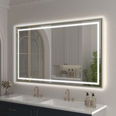 a bathroom with two sinks and a large mirror on the wall over it's sink