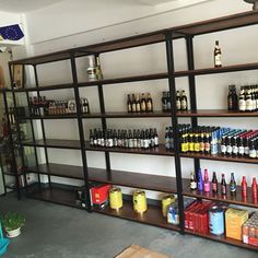 the shelves are full of bottles and cans