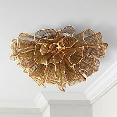 a light fixture hanging from the ceiling in a room with white walls and trimmings