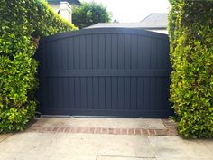 a large gate is shown between two hedges