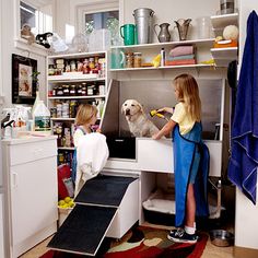 two children and a dog are in the kitchen