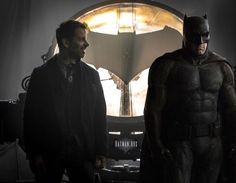 the dark knight and batman are standing together