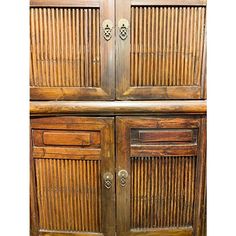 an old wooden cabinet with two doors and drawers