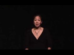 a woman standing in front of a black background