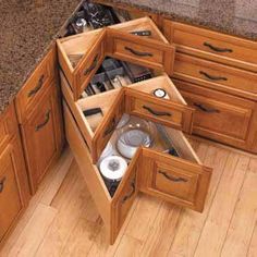 an open drawer in the corner of a kitchen