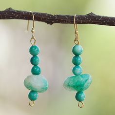 Turquoise hues will transport you to a paradisiac lagoon with a refreshing aura, all thanks to Victor Dushie's talented hands. The Ghanaian artisan uses recycled glass beads and agate chips, symbolizing vitality, to create these dangle earrings equipped with brass hooks, making them perfect for a fun outing with friends or loved ones. Green Jade Gemstone Bead Earrings, Green Jade Earrings With Gemstone Beads, Turquoise Jade Earrings With Natural Stones, Green Jade Earrings For Healing, Handmade Turquoise Jade Earrings, Turquoise Dangle Earrings With Amazonite, Turquoise Amazonite Dangle Earrings, Adjustable Green Beaded Earrings With Natural Stones, Handmade Turquoise Amazonite Earrings