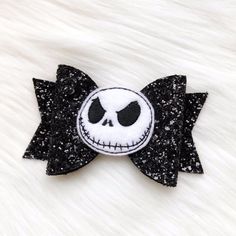 a black and white hair bow with a skull on it