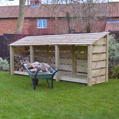 a garden shed with a wheelbarrow and firewood