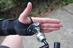 a person with their hand on the handlebars of a bike showing thumbs up