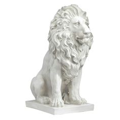 a white lion statue sitting on top of a table