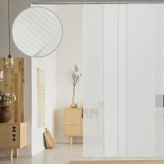 a living room with white walls and wooden furniture on the floor next to a sliding glass door