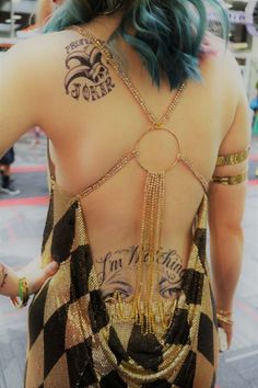 the back of a woman with tattoos on her upper and lower part of her body