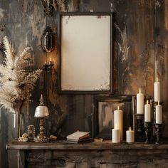 a table topped with lots of candles next to a mirror and framed photo on the wall