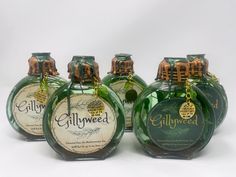 three green bottles with labels on them sitting next to each other