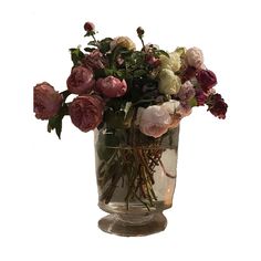 a vase filled with lots of flowers on top of a table