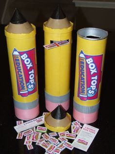 two yellow crayons and some stickers on a table with other items around them