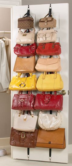 a rack with purses and handbags hanging from it's sides in front of a closet