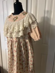 This is a gorgeous vintage Victorian/English farm style dress. Reminds me of Little House on the Prairie!  This dress is quite small and fit on a small size 1-3 mannequin Armpit to armpit 21" Collar 9" across  Top of shoulder to sleeve end 13" Sleeve diameter 12"  Length approx 44" It is in perfect condition Cottagecore Victorian Dress With Lace Trim For Garden Party, Pastoral Cotton Dresses With Lace Trim, Pastoral Prairie Dress With Ruffles For Garden Party, Cottagecore Dresses With Lace Trim, Pastoral Prairie Dress For Garden Party, Cotton Cottagecore Dress With Floral Embroidery, Vintage Cotton Dress For Garden Party, Cottagecore Victorian Dress For Daywear, Cotton Vintage Dress For Garden Party