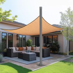 an outdoor living area with couches and tables