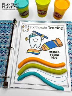 toothpaste tracing and orange yellow blue playdoughs on a table