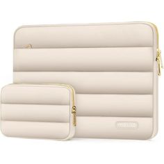 two white laptop cases sitting next to each other on a white surface with gold zippers