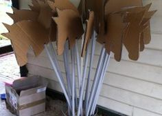 cardboard leaves are placed in a bucket on the ground