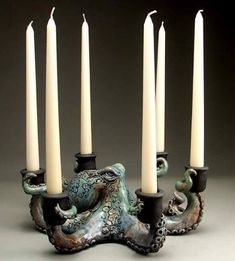 an octopus candle holder with five candles in it's center and one on the other side