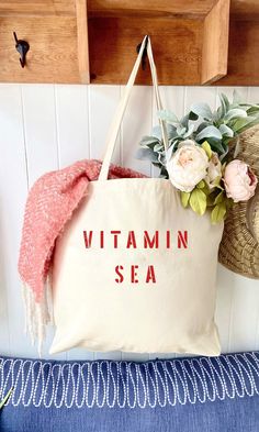 The VITAMIN SEA over sized canvas tote bag is perfect minimalist bag for a trip to the beach!  Available with text in several colors... check out the variations!  This bag is made from 100% thick, sturdy canvas. AVAILABLE IN TWO SIZES * Large - 19.5" x 13" with a 4" gusset *Jumbo - 23" x 13" with a 6" gusset   These bags are hand painted using non-toxic fabric paint.  The technique used creates an attractive distressed appearance to the text that varies from bag to bag.  All of my products are m Cotton Canvas Bag For Daily Use And Beach Season, Large Capacity Cotton Bag For Beach Season, Cotton Beach Bags For Daily Use, Trendy Cotton Tote Beach Bag, Summer Beige Cotton Canvas Bag, Casual Cotton Beach Bags, Summer Canvas Bag With Large Capacity, Summer Large Capacity Cotton Canvas Bag, Trendy Canvas Bag For Beach Season