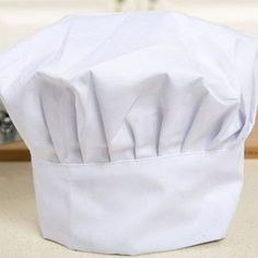 a white chef hat sitting on top of a counter