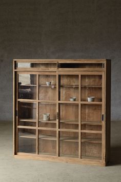 a wooden cabinet with glass doors and shelves