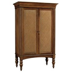 an armoire with wicker doors and wood trimmings on the bottom shelf