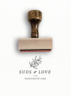 a rubber stamp with the words suds & love on it and an olive branch