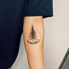 a man with a pine tree tattoo on his arm