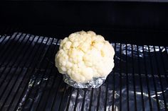 cauliflower is sitting on top of the grill