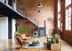 a living room filled with furniture and lots of wood flooring on top of a hard wood floor