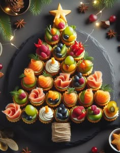 a christmas tree made out of cupcakes and fruit