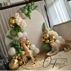 a giraffe and zebra balloon arch for a baby shower