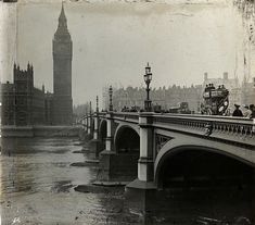 an old black and white photo of the big ben clock tower towering over the city of london