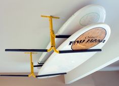 two surfboards are hanging from the ceiling