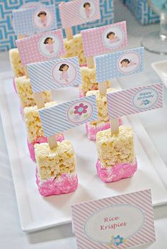 cake pops are displayed on a plate with place cards for the guests to write their names