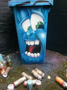 there is a trash can with an evil face on it and many cans around it