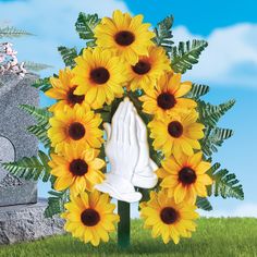 there is a wreath with sunflowers and a white glove in front of it