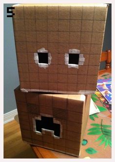 a cardboard box that has been made to look like a house with eyes and mouth