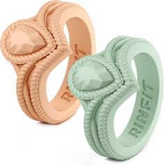 two rings with different designs on them, one is light green and the other is light pink