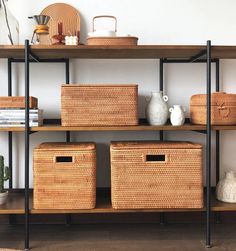 some baskets are sitting on top of a shelf