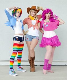 three women dressed in costumes posing for the camera