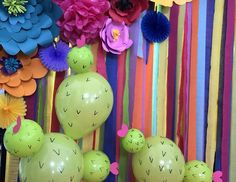 colorful paper flowers and fake cactuses are on display