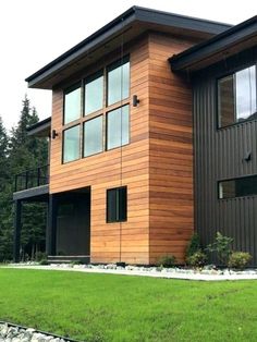 a modern house with wood siding and windows